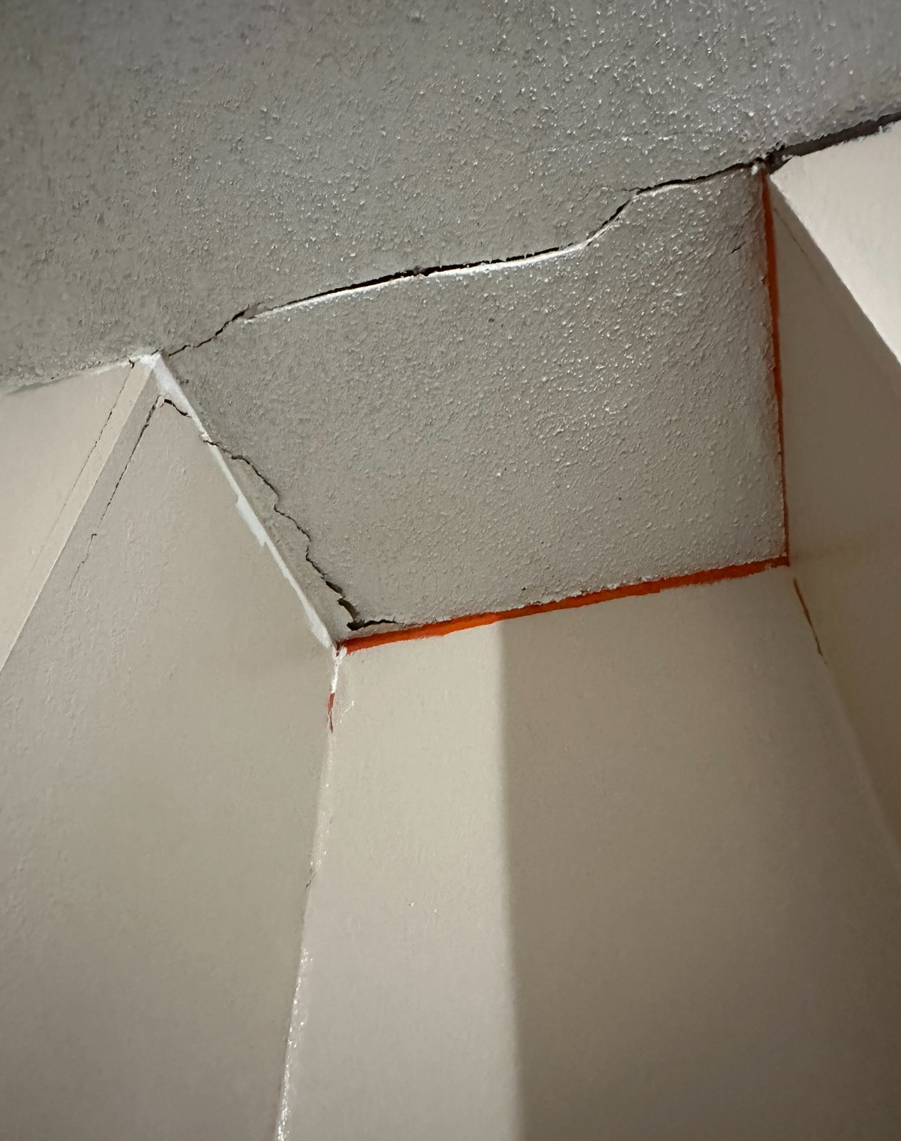 Cracked ceiling corner needing drywall repair